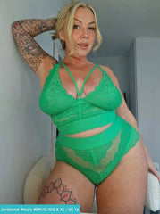 Person wearing green lace lingerie in a bathroom setting